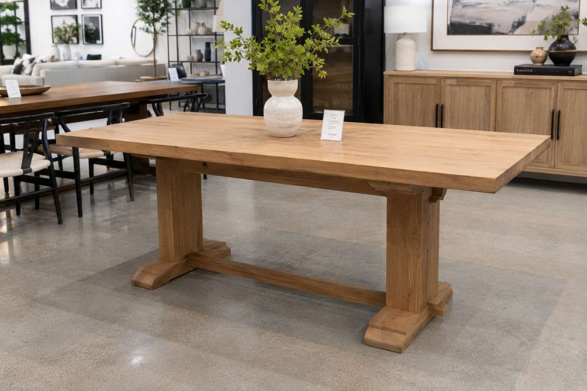 Wooden dining table in a bright furniture showroom