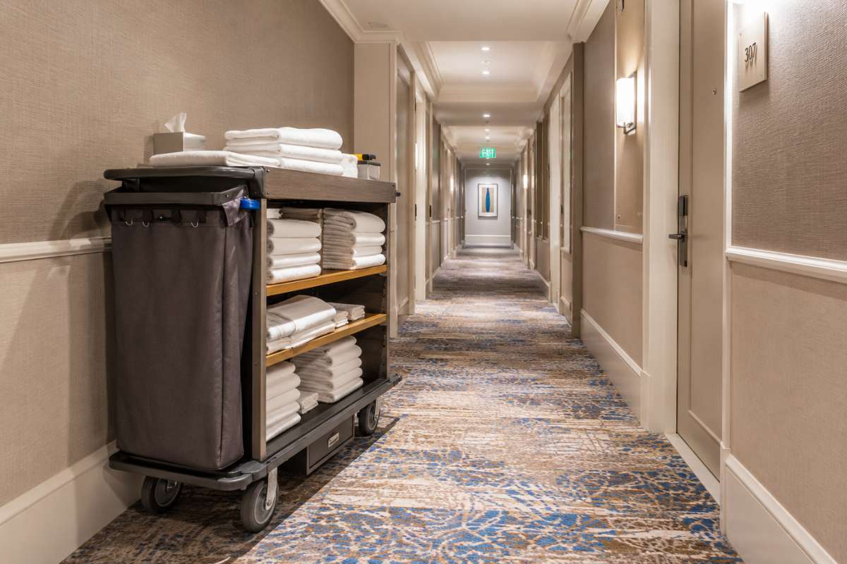 Hotel corridor with room service trolley and clean linen